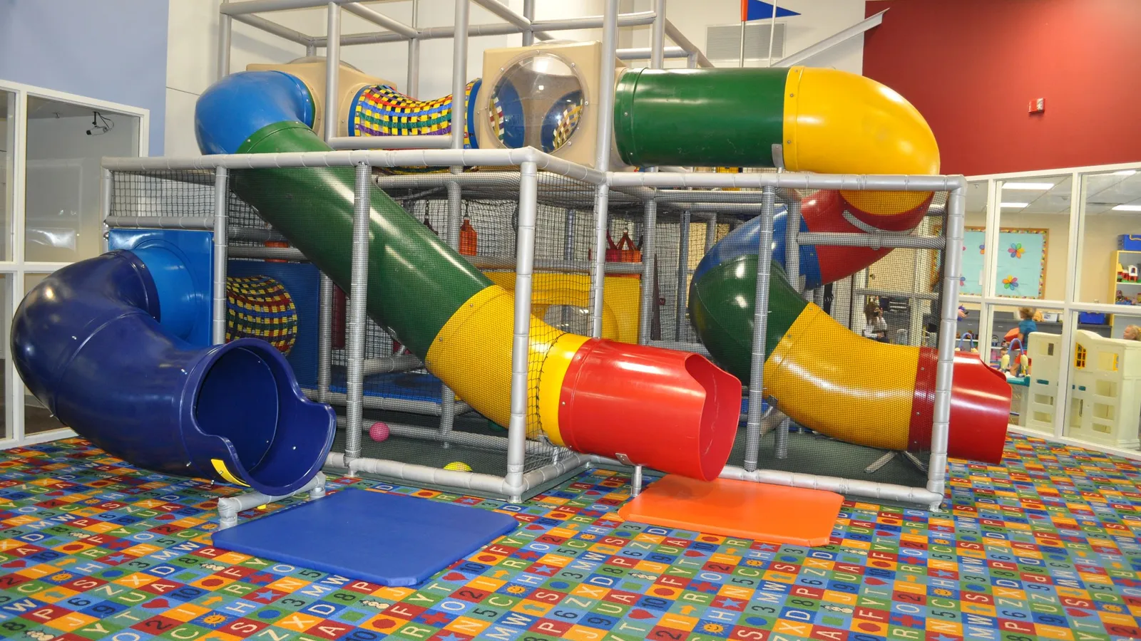 Kids playing on the indoor play structure at Chaska Community Center