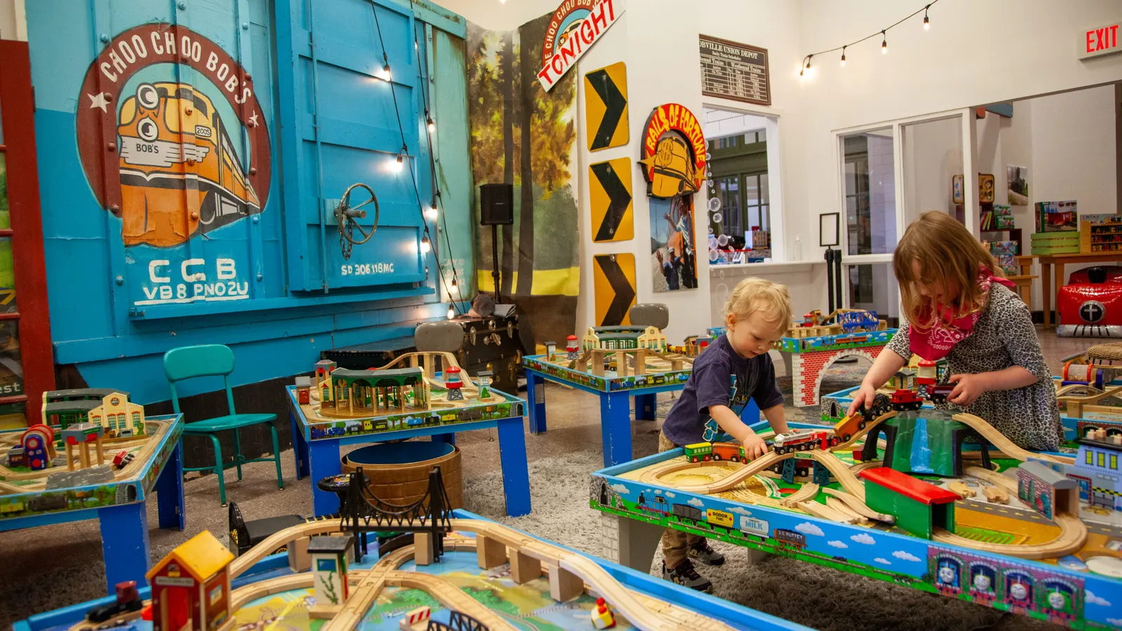 Children playing with trains at Choo Choo Bob’s play tables