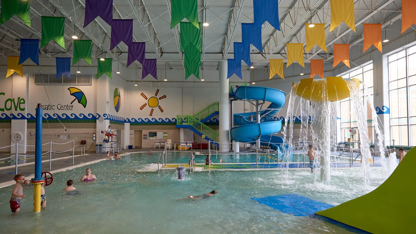 Families splashing at Grove Cove Aquatic Center in Maple Grove