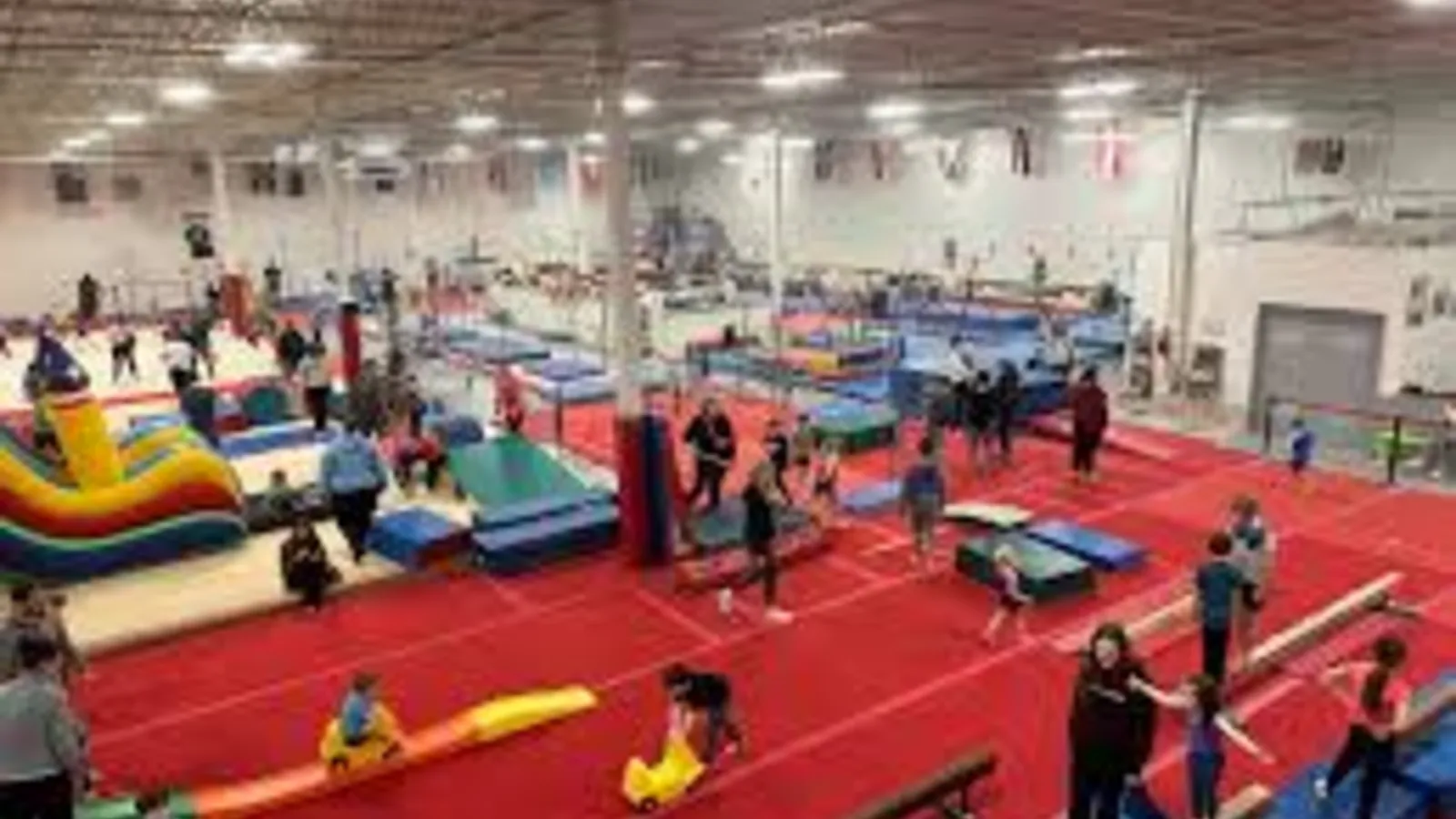 Preschoolers jumping into foam pits at IGM Gymnastics
