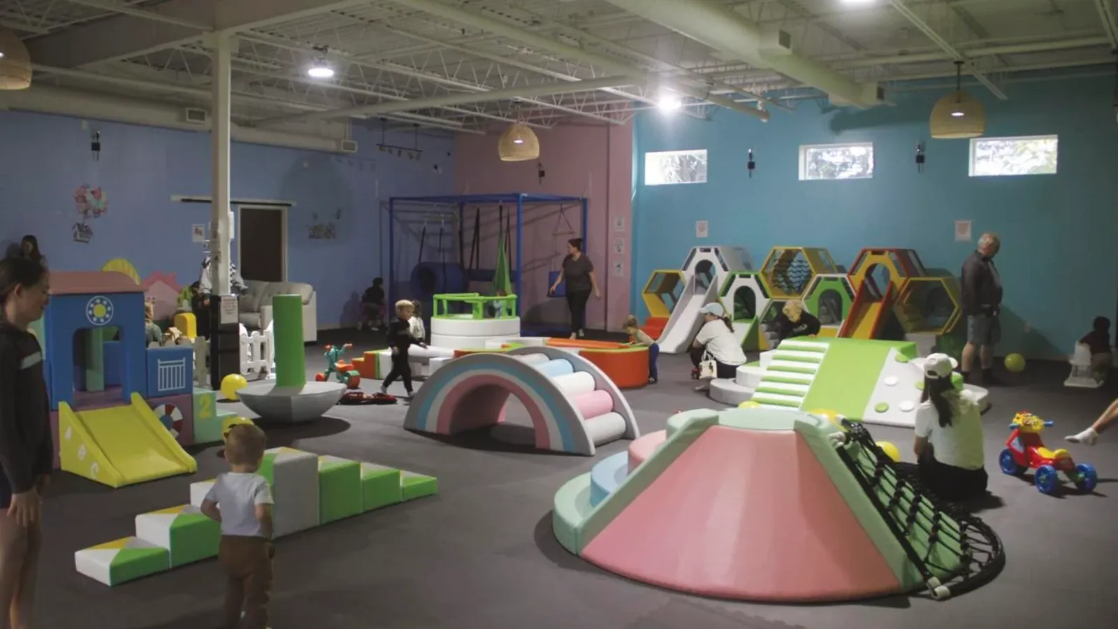 Children playing on slides inside Little Play Date