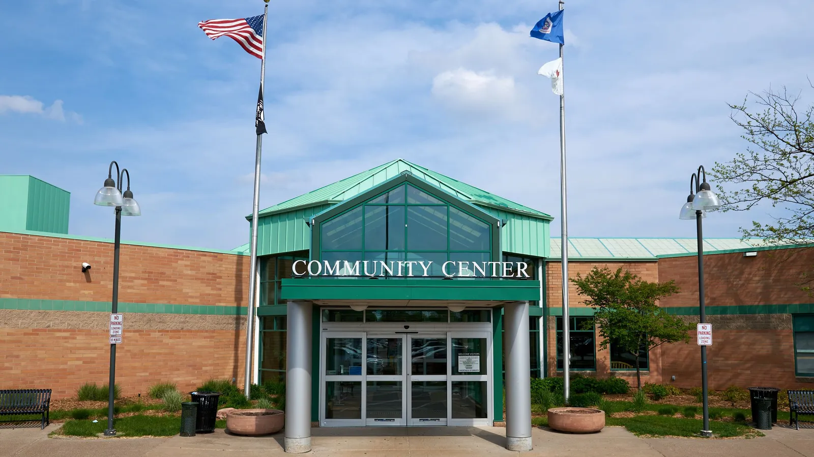 Toddlers riding scooters in the Maple Grove Community Center gym