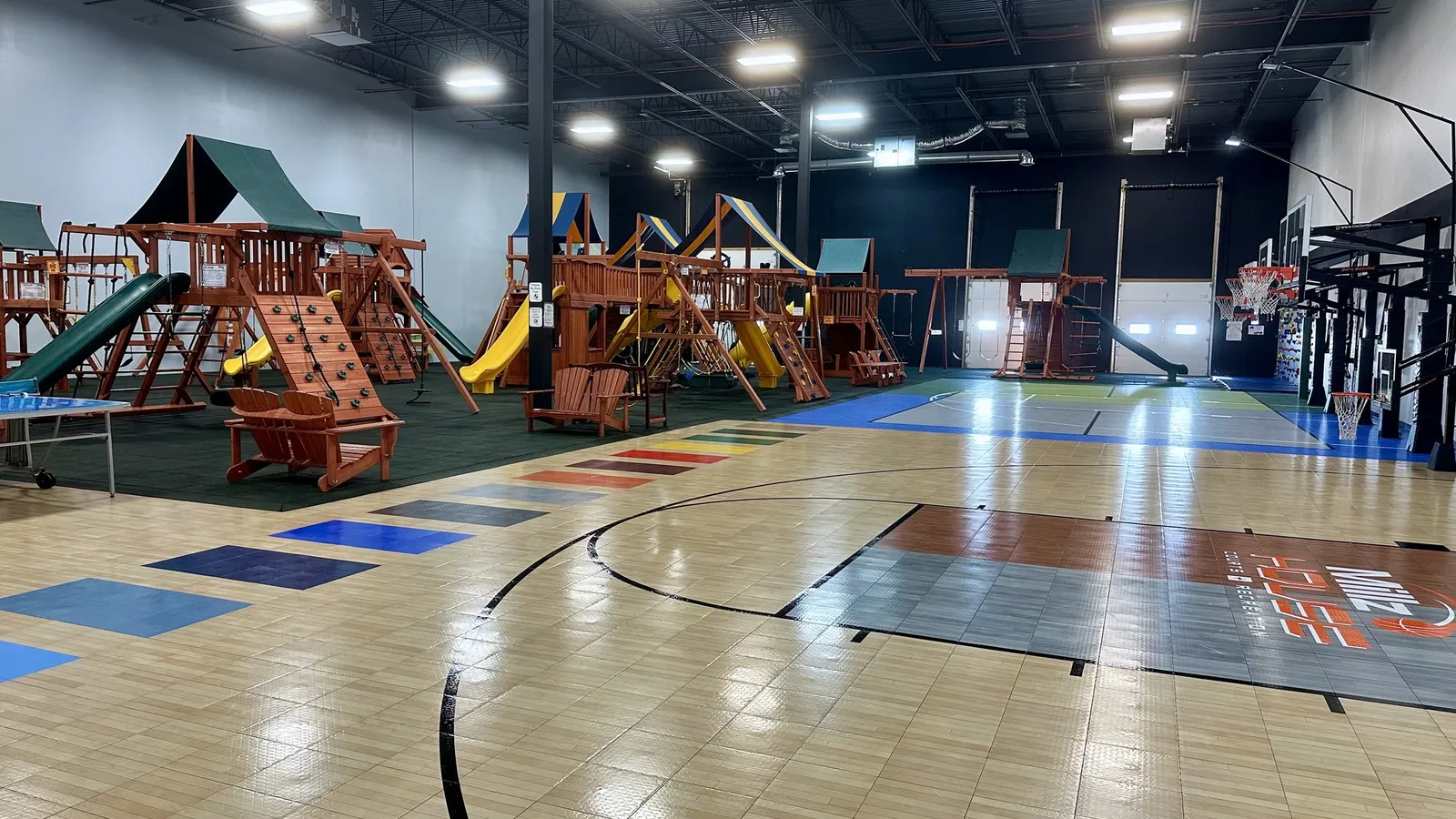 Kids climbing on indoor playsets at Millz House