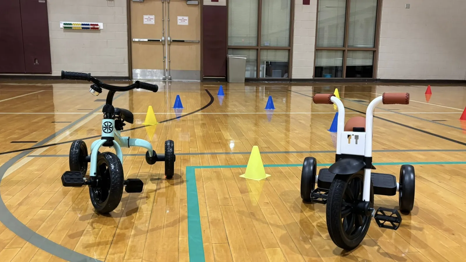 Children riding scooters in the Mounds View Community Center gym