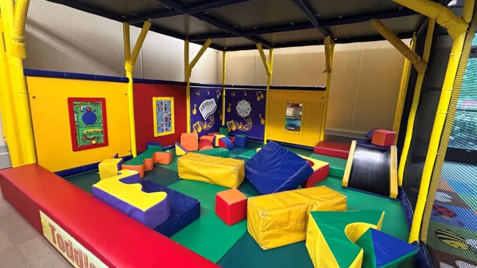 Children playing on small slides at Prairie Play Zone