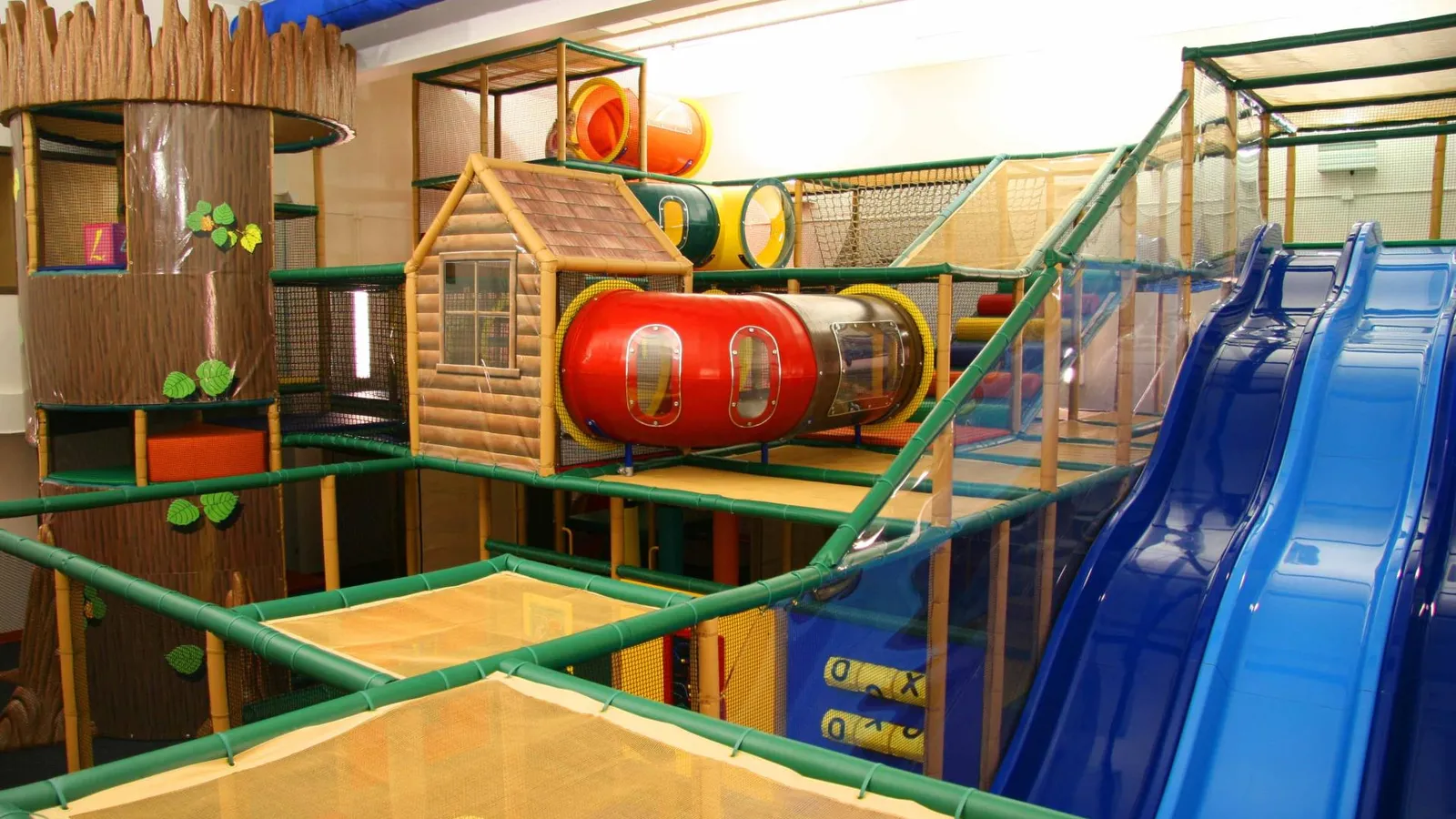 Children climbing inside the Williston Treehouse indoor playground